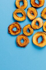 slices of dried persimmon on a blue background. dried fruits. eco.
