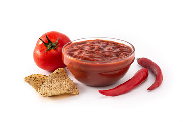 Spicy chili sauce in bowl with nacho chip isolated on white background