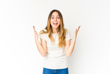 Young caucasian woman isolated on white background receiving a pleasant surprise, excited and...