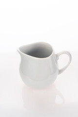 White empty jug for coffee cream, vertical