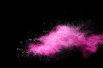 Pink powder explosion on black background. Paint Holi.