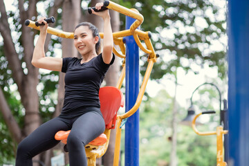 Asian women are playing exercise machines at the park.