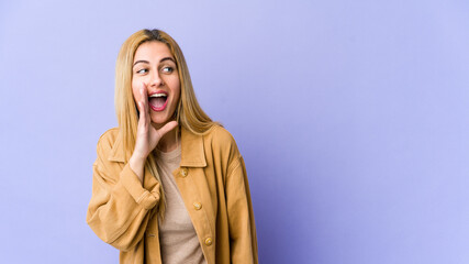 Young blonde caucasian woman shouting excited to front.