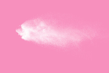 White powder explosion on pink background. Paint Holi.