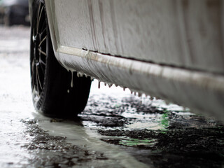 car in foam auto shampoo. self-service car wash. black disks in foam.