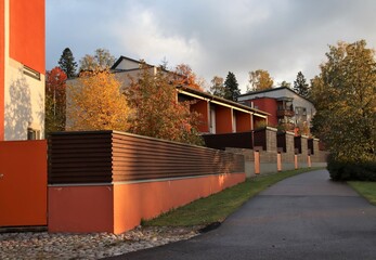 A suburban street on beautiful evening light in the autumn. Scandinavian architecture. The photo is...