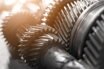 shafts with gears of a gearbox on a table in a car service. Close up