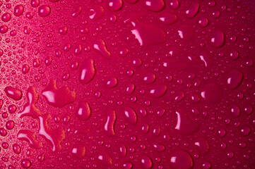 Drops of water on a red glass texture background