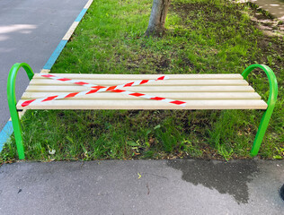 A bench covered with restraining tape. Social distancing. Moscow