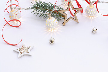 Christmas composition of wooden stars with sparkles, garlands of white luminous balls, fir branches...