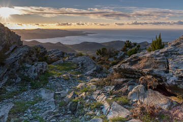 Stones and  Autumn vegetation in the mountains of Corsica with the sea in the background