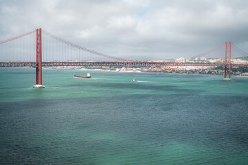 a large road bridge that stretches over the river. fantastic color of green water