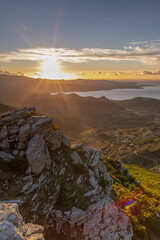 Stones and  Autumn vegetation in the mountains of Corsica with the sea in the background