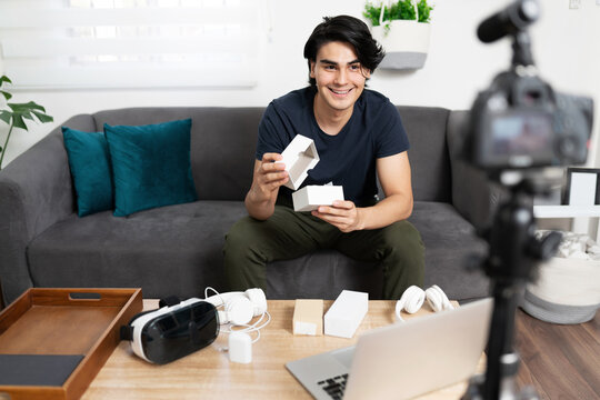 Young Man Reviewing Some Tech Devices