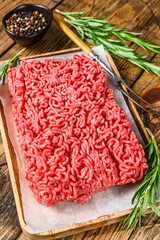 Raw Mince Ground meat. wooden background. Top view