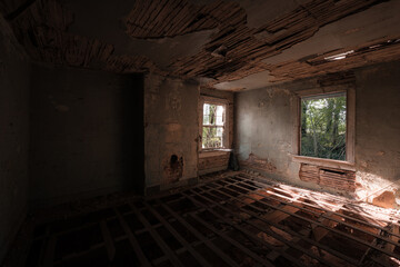 This is an interior of a bedroom that has been stripped of its flooring and is down to its wood joists at a long-abandoned house in Virginia.