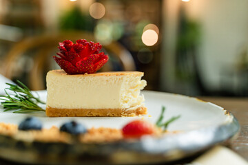 Close-up picture of delicious cakes on beautifully decorated ceramic plates and bokeh background.
