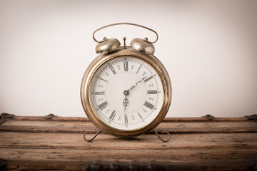 Vintage Metal Alarm Clock on Old Wooden Trunk