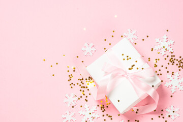 Christmas flat lay background with christmas present box on pink.