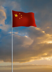 Chinese flag waving during sunset