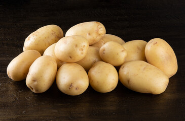 Pile of potatoes lying on rustic background