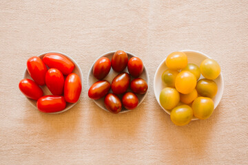 Different kind of organic tomatoes in a bowl. 