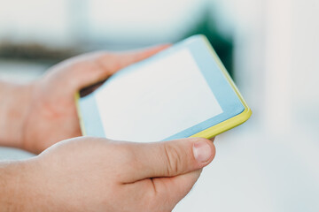 shot of male hands holding modern tablet pc mock-up outdoors
