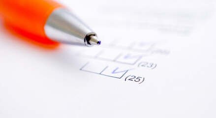 orange pen and financial document closeup