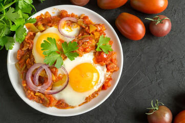 Sunny side up egg with stewed tomatoes.