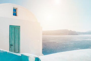 House in the mountain overlooking the sea and volcan in a sunrise oia santorini greece