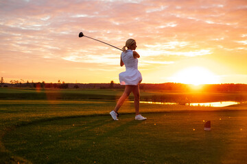 Lady Play Golf With Sunset Background .