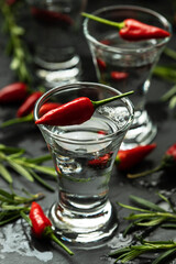 Shot glasses filled with clear cold alcohol drink