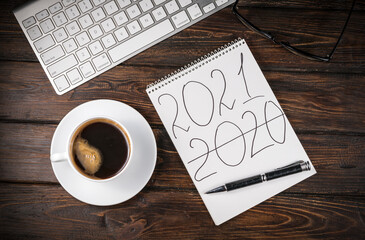 cup coffee and Notebook with Notepad on the table.