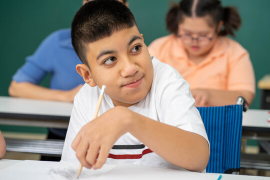 disability kid on wheelchair with Autism child in special classroom