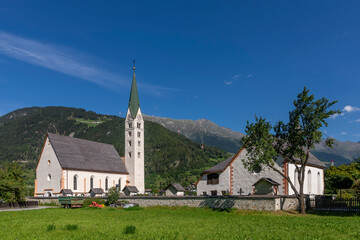 Fototapeta na wymiar The Pfarrkirche Maria Himmelfahrt parish church in the historic center of Prutz, Austria, on a sunny day