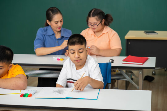disability kid on wheelchair with Autism child in special classroom