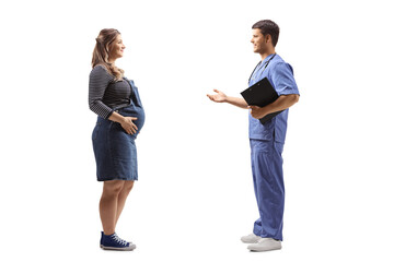Fototapeta premium Full length profile shot of a doctor in a blue uniform talking to a pregnant woman