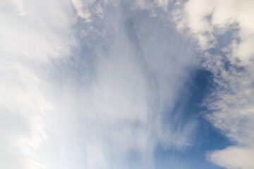 Naklejka na ściany i meble White cirrocumulus clouds in the blue sky. Beautiful blur sky background