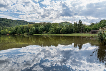 Lake in The Forest with Blue Cloudy Sky 