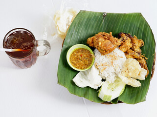 Nasi Uduk Ayam Goreng with Ice Tea, Homemade of famous Indonesian Cuisine