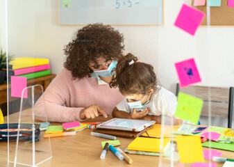 Teacher with children wearing face mask in preschool classroom during corona virus pandemic - Healthcare and education concept