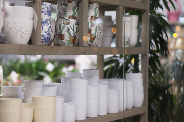 Flower pots on the shelves of a flower shop in a shopping mall