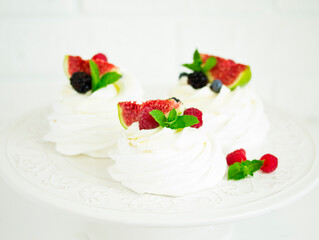 Pavlova's meringue dessert with berries and fruits