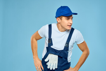 Working man in uniform of gloves loader rendering service blue background