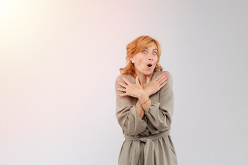 Portrait of wondered charming adult woman with mouth opened over white background
