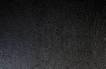 Black texture background. The dark embossed background.