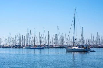 Yachts and  sailing boats on calm water, clear blue sky. Seascape.