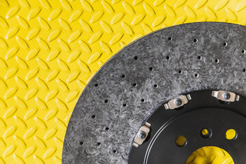 black carbon brake disc on yellow background