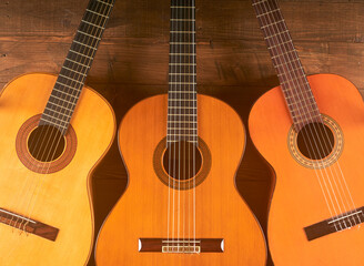 Fototapeta na wymiar classical guitars in wooden background