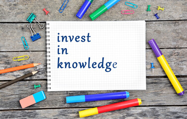 Invest in knowledge written on notebook